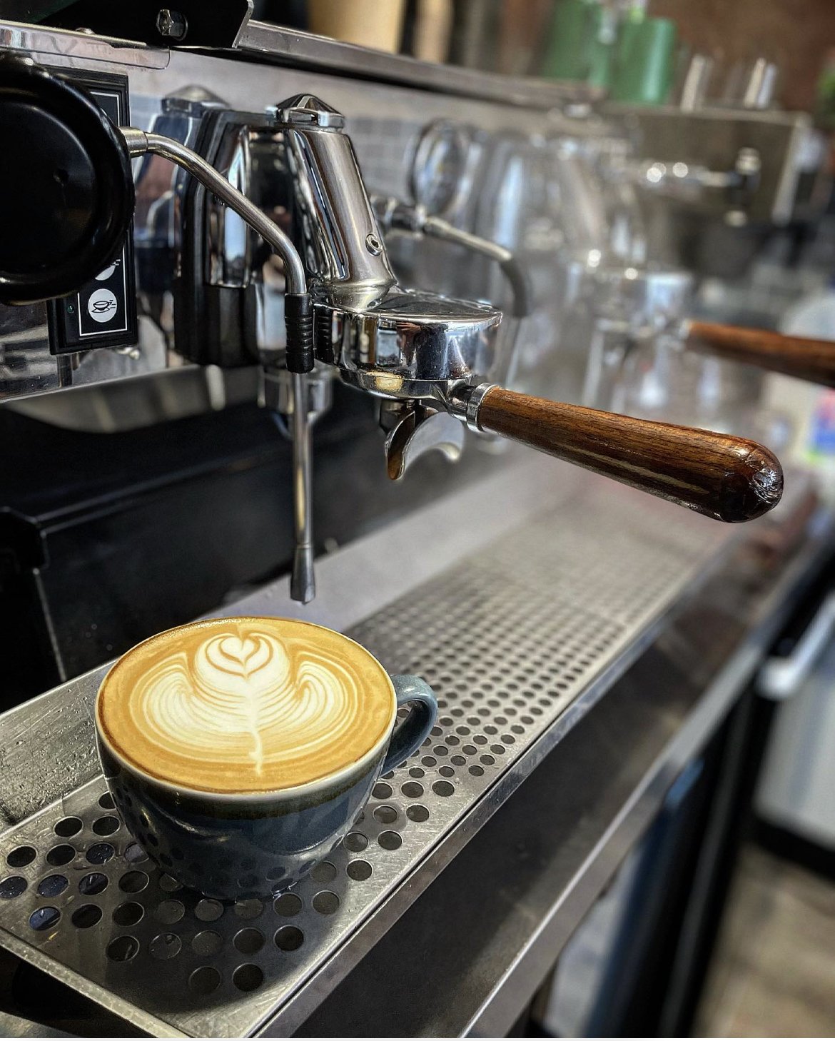 A latte art heart being poured into a cup